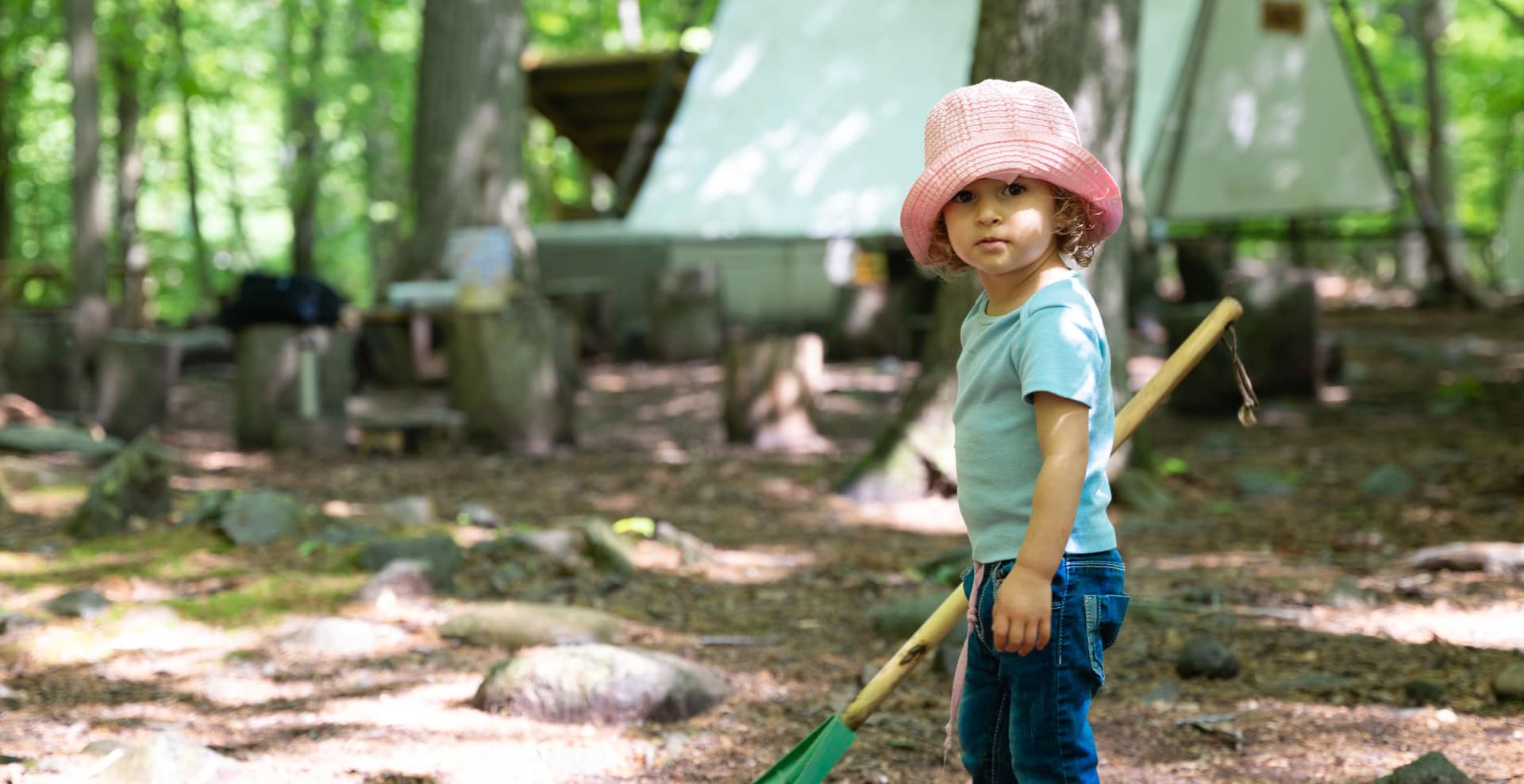 Child holding rake.